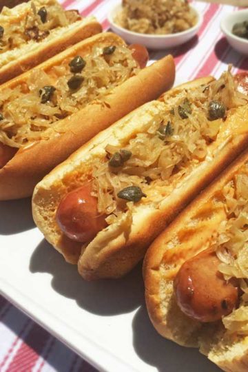 Hot Dogs Topped with Sauerkraut and Capers